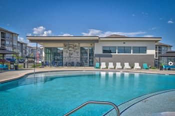 a swimming pool with a building in the background